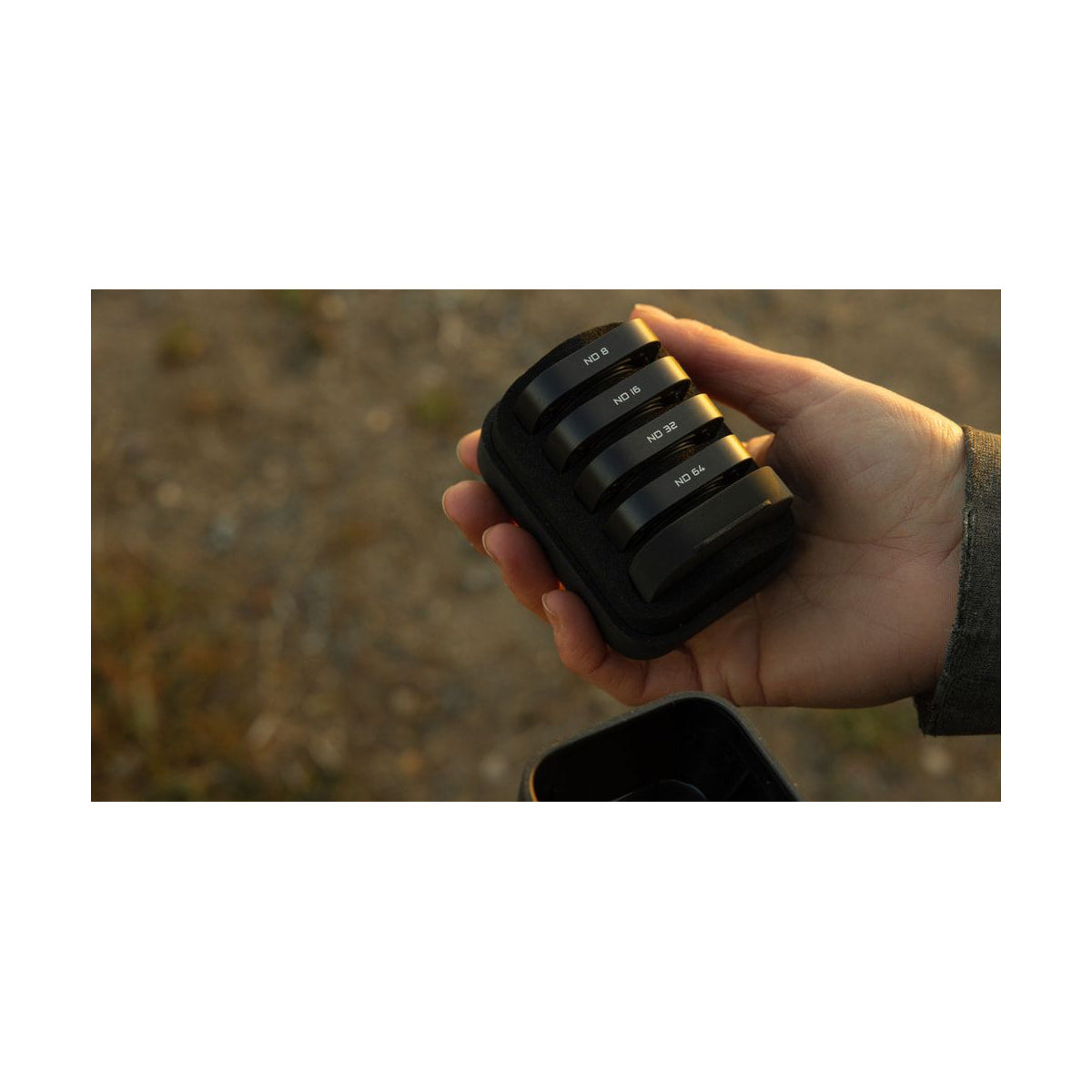 GoPro ND Filter 4-Pack for Mission 1 Cameras — hand holding four filter storage case view