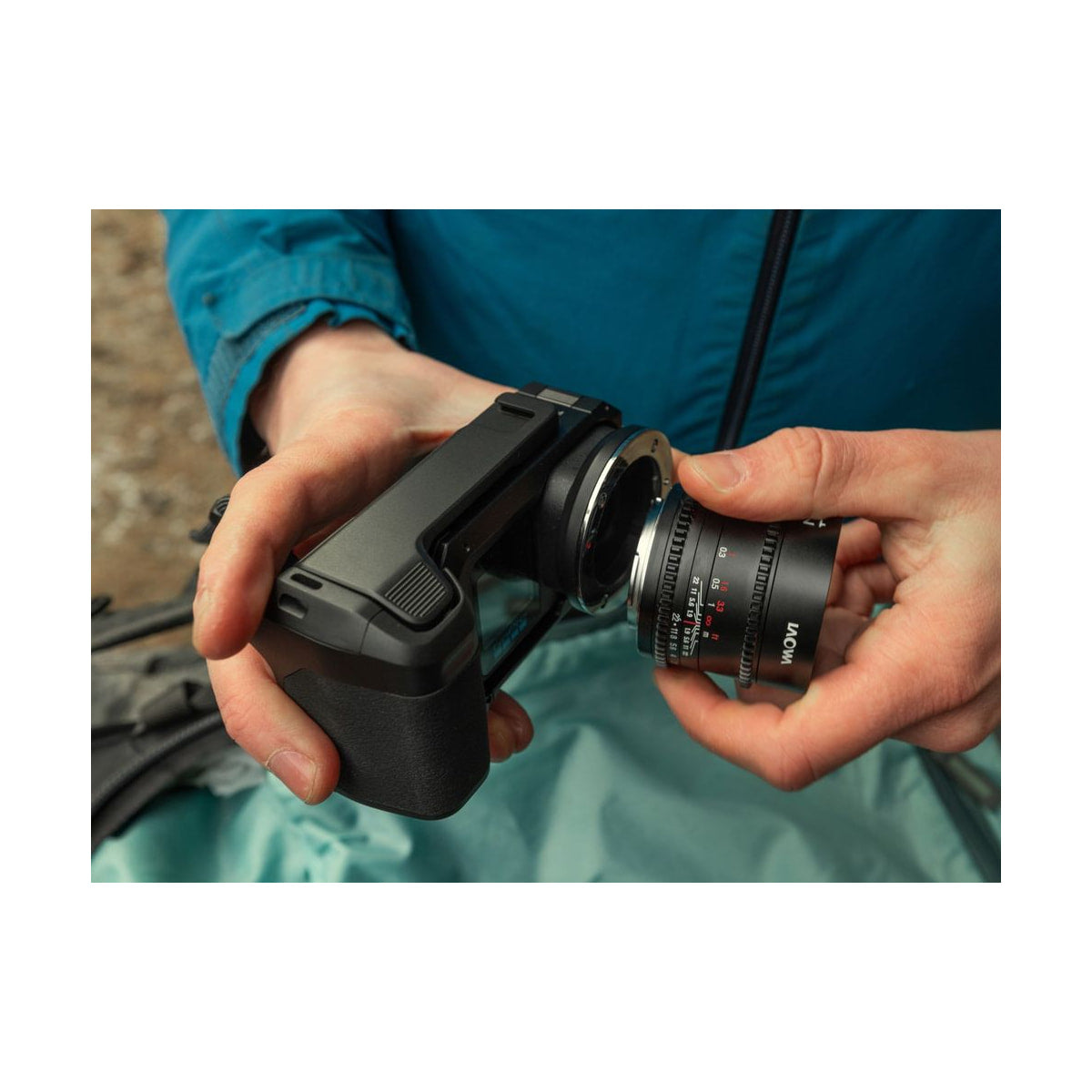 GoPro Mission 1 Pro ILS Camera — hands attaching a cine lens to the camera body view