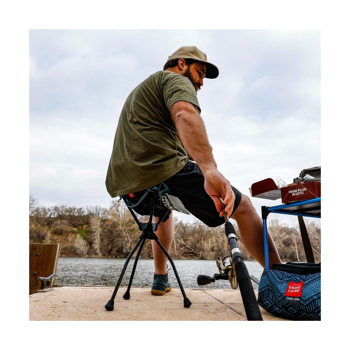Grand Trunk Compass 360° Extra-Tall Swivel Stool (20", Black) — black stool in use outdoors rear side view 2 view