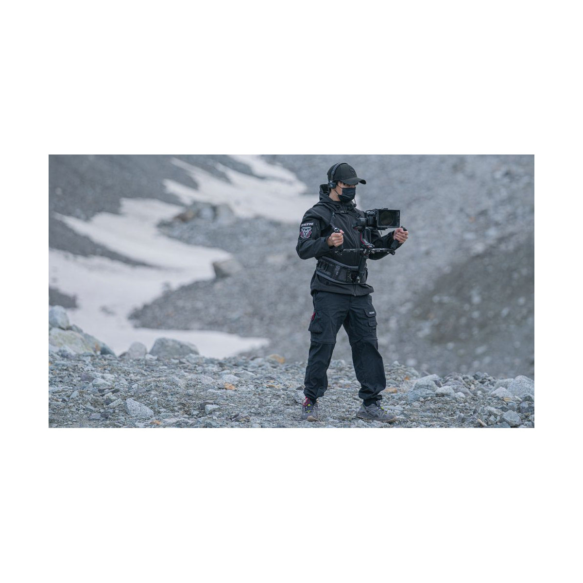 Tilta Dual Handle Bracket for DJI Ronin — operator holding dual handle bracket with camera rig view