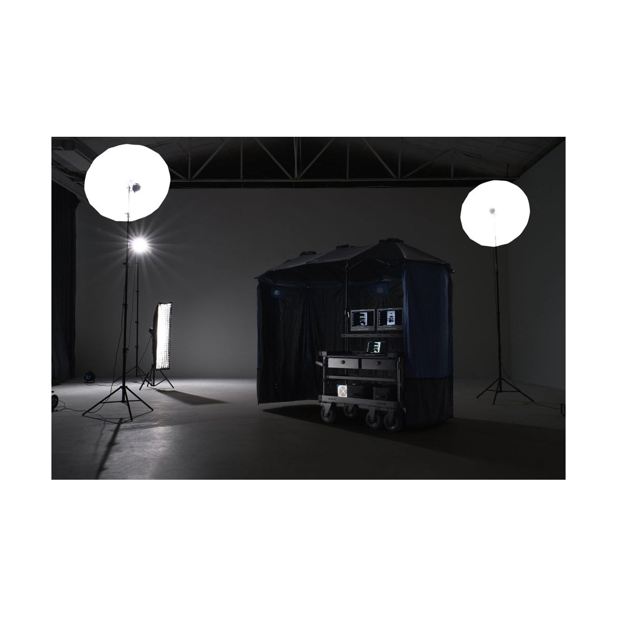 Tilta Extended Umbrella Kit for Boulder Camera Cart (Black) — umbrella kit in use on a production cart view