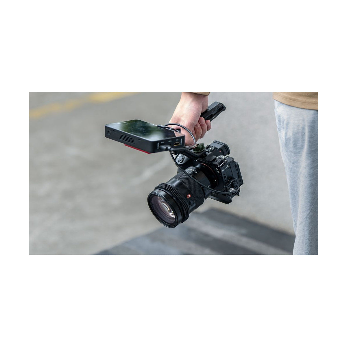 Tilta Full Camera Cage for Sony A1 II and A9 III — cage mounted camera with monitor being carried view